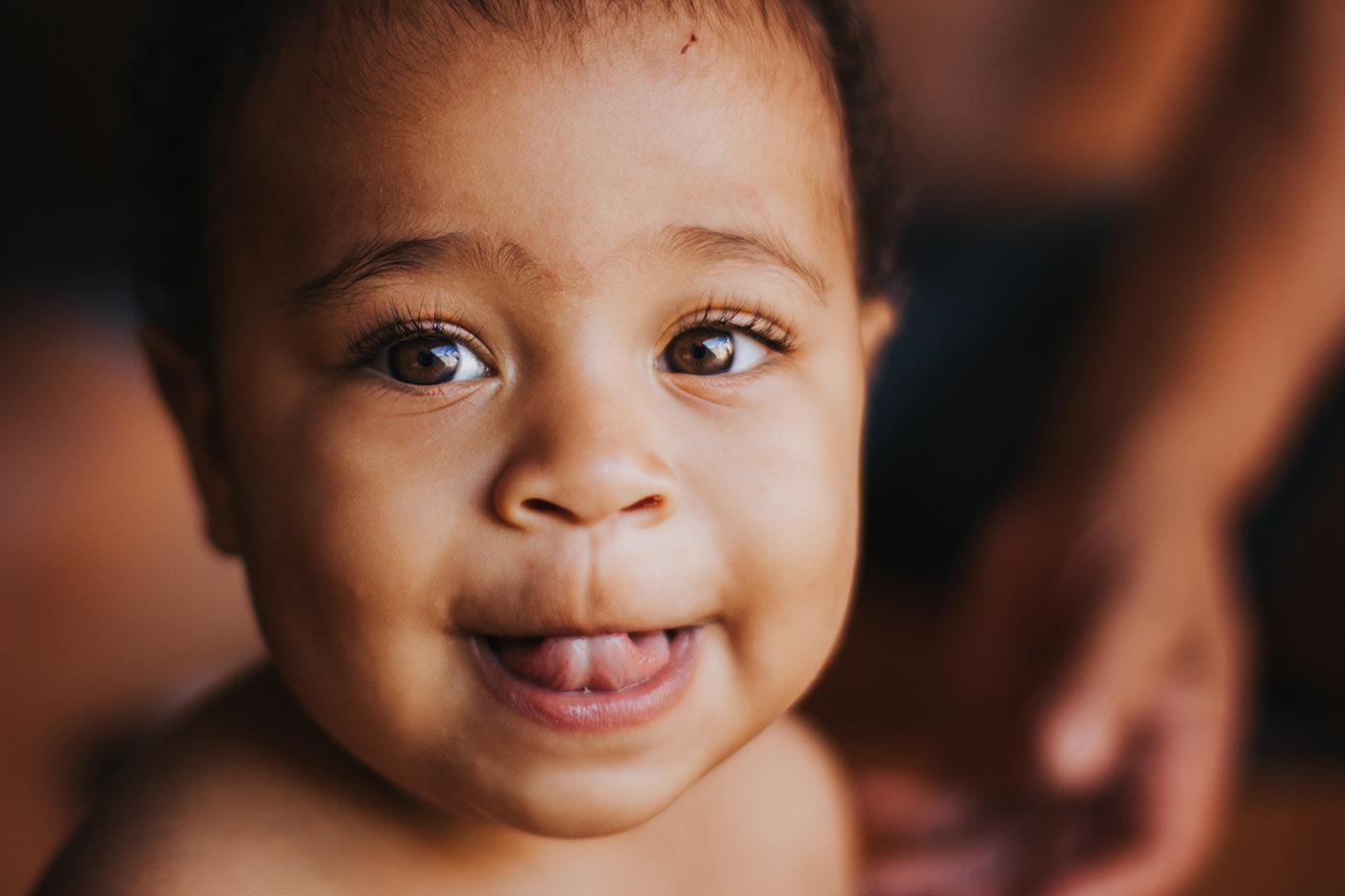 Close-up of baby's face with tongue sticking out